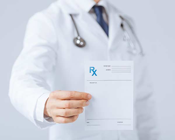 Adjuvant-medication-shoreside-interventional-pain-sarasota-FL Docotr holding prescription. NWA Interventional Pain in Rogers, AR.