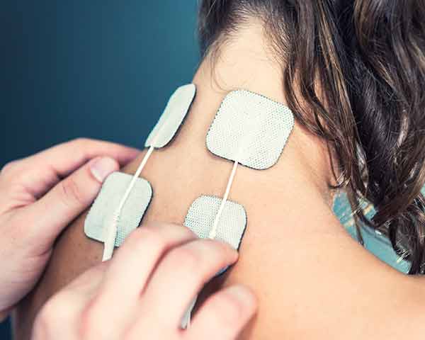 TENS-Units-Shoreside-pain-sarasota-florida TENS Units being placed on a persons neck. NWA Interventional Pain, Rogers, Arkansas.