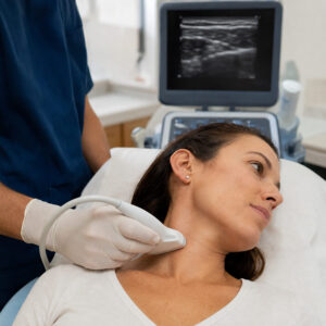 Clinician uses an ultrasound probe on a patient’s neck while preparing for a stellate ganglion block.